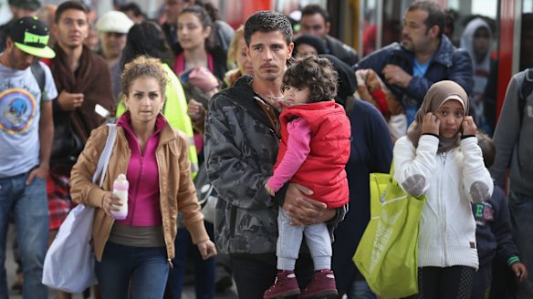 Migrants who had arrived from Hungary arrive to be led by police to a registration center in Munich, Germany.