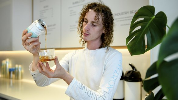 James Kuhle, store manager of Industry Beans on Little Collins Street in Melbourne, pouring the roaster's new cold brew from a can.