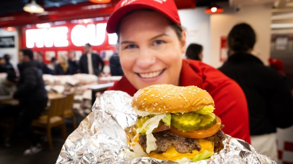 Robby Andronokis of Five Guys with one of its customised cheeseburgers.