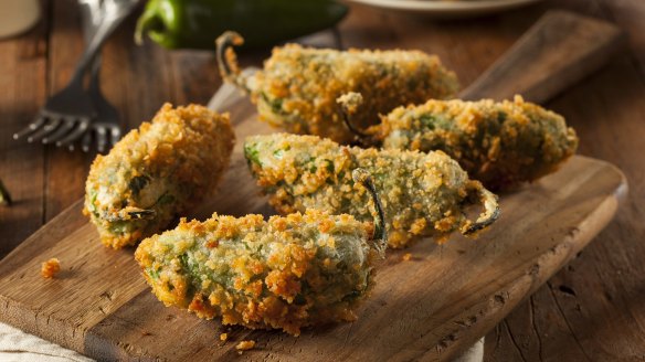 Jalapeno poppers, stuffed with cream cheese, crumbed and deep-fried, make an irresistible snack.