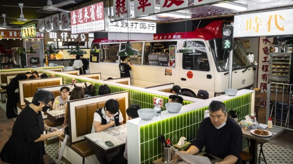 Cantonese traffic signs and a retired minibus help recreate a Kowloon streetscape.