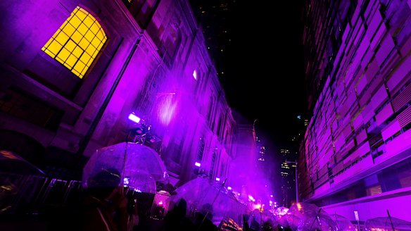 Melburnians enjoy the Purple Rain installation.