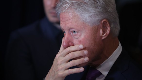 Bill Clinton listens as his wife Hillary Clinton delivers her concession speech in New York.