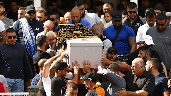 Relatives and friends of Safwan Charbaji, who was shot dead in Condell Park, carry his coffin outside Lakemba Mosque.