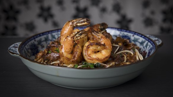 The prawn char kwai teow is tossed over high heat until smoky and soy-blackened.