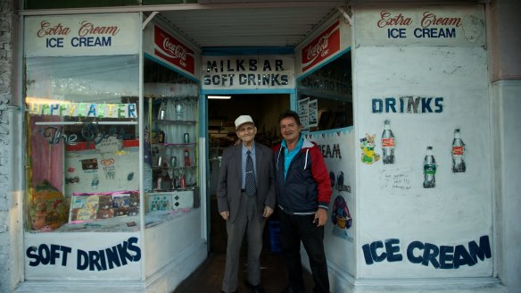George Poulos with his son Nik in Summer Hill. George served his customers dressed in a suit and tie every day.