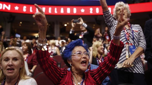A delegate with blue hair cheers during the Republican National Convention in Cleveland, Ohio, in July. 