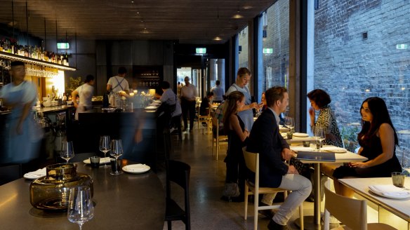 New laneway spot Beau Bar is a moody, shadowy space built around a swish black granite island bar.