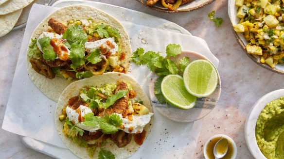 Hands-on feasting: Pork fajitas with pineapple and corn salsa, guacamole and sour cream.