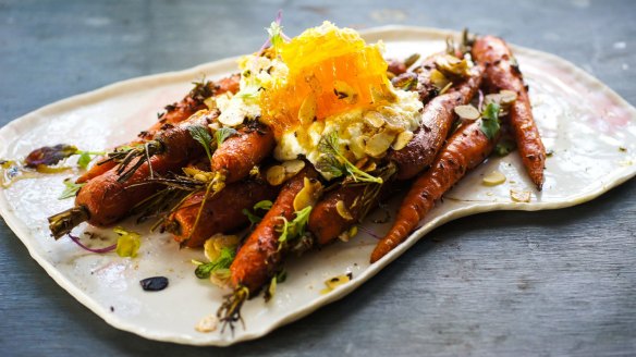 Roasted carrots with a hunk of fresh honeycomb.