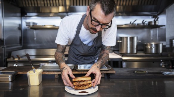 Odd Culture Chef Jesse Warkentin prepares a bacon sandwich with Japanese Bull-Dog sauce on the side.