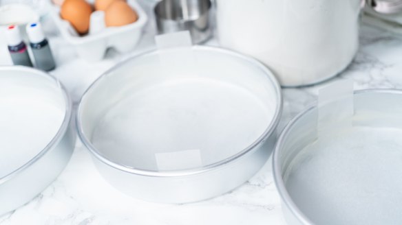 Butter or baking spray is your friend when lining cake tins with with baking paper.