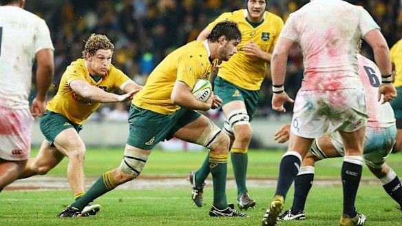 Lumbering forward: Sam Carter is tackled despite a bit of help from Michael Hooper.