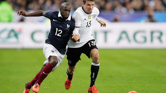 French footballer Lassana Diarra competes with German opponent Thomas Mueller during the match.
