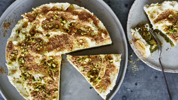 Mafroukeh cake topped with clotted cream, toasted kishk and pistachios.