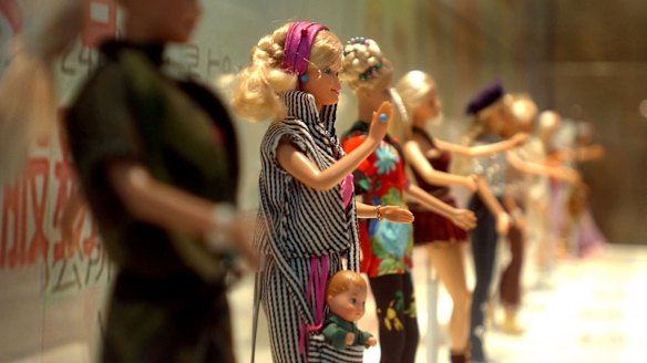 Barbie dolls in various outfits at the makeshift Barbie museum, in 2004. 