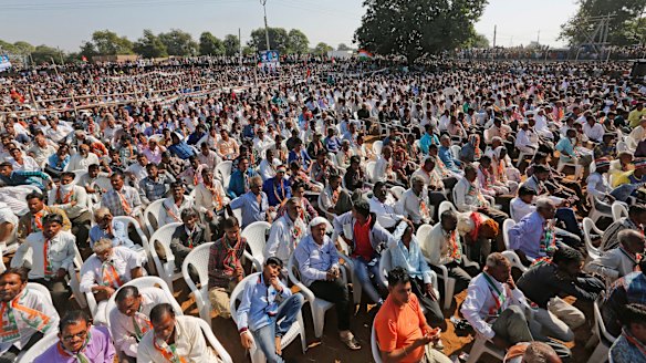 People listen to Rahul Gandhi during an election rally near Bayad in Gujarat state in November.