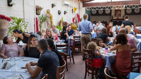 Seasonal strings of tinsel brighten the whitewashed decor at Jim's Greek Tavern.