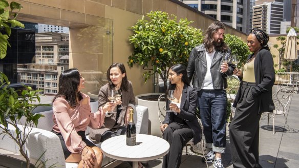 Sommelier Shun Eto (second from right) clinks fizz with guests at Shell House in Sydney's CBD.