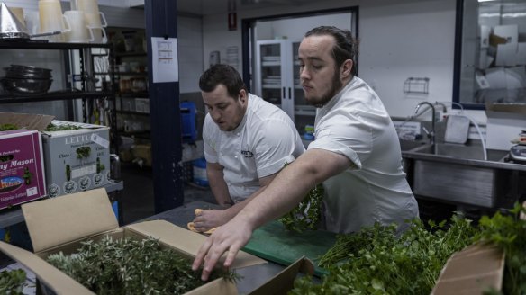 Sam (left) and Luke Bourke, collect produce at Stix Catering in Marrickville.