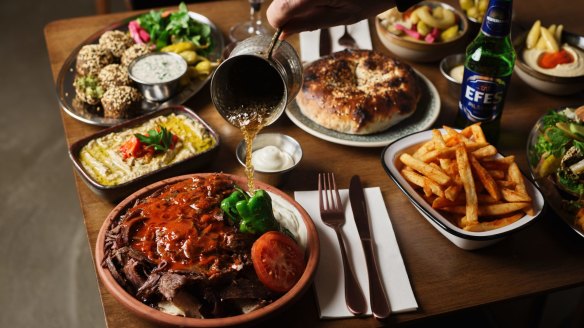 Spread with doner served iskender style with bread, falafel and dips.