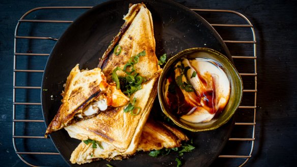 Ma po tofu jaffles with optional dipping sauce.