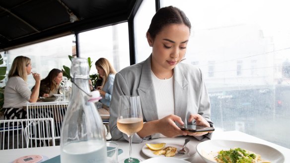 Athina Christie pays for her meal at Hotel Ravesis in Bondi with Payo. The app is similar to Afterpay except it can only be used in hospitality venues.