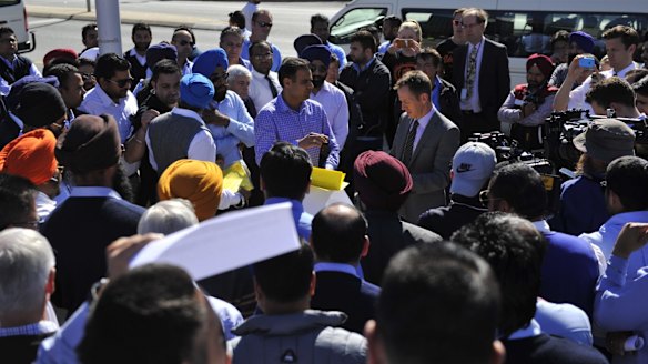 Shane Rattenbury is swamped by taxi owners and drivers.