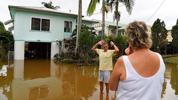 Tracey (right) and Laurie Batshaw (left) in front of their house in flooded Bright street in Lismore. 