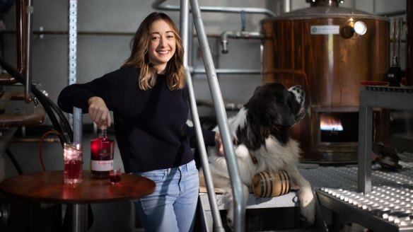 Bass & Flinders distiller Holly Klintworth with her dog Gilbert and pinot-infused gin. 