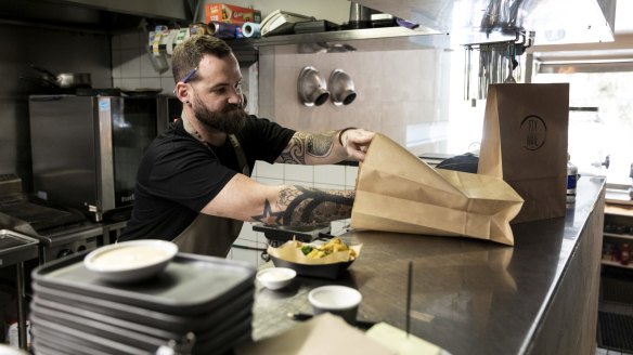Chef Mark Archer prepares takeaway meals at Fix Wine Bar and Restaurant.