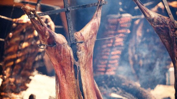 Traditional Argentinian asado features whole animals grilled on a cross.