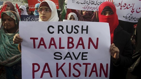 Protesters condemn the Taliban attack on a military-run school in Peshawar.