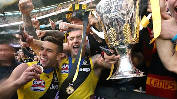 Mayhem: Dustin Martin and Jack Graham with the premiership trophy.