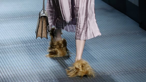 In this Wednesday, January 5, 2015 file photo, a model wears footwear with wisps of fur as part of the Gucci women's Fall-Winter 2015-2016 collection, in Milan, Italy. 