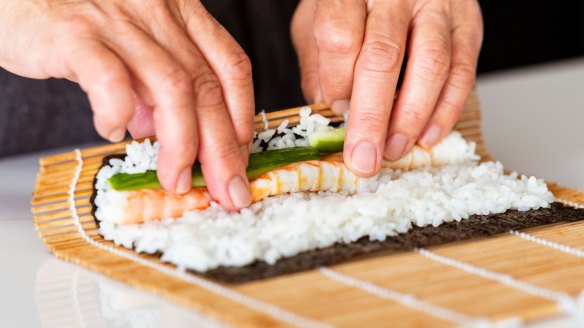 Step-by-step sushi rolls.
Step 3a. Lift the near edge of the mat over the filling, using your fingers to hold everything in place.ÃÂ 
Pic credit: Nagi Maehashi
For Good Food, April 26, 2022