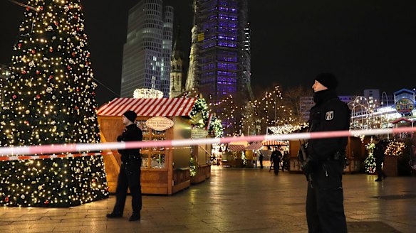 Police guard a Christmas market in Berlin, after a truck ploughed into the crowd.