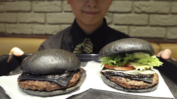 Black buns, black sauce and black cheese: Burger King Japan's limited edition "Kuro" burgers. The Kuro Diamond burger, right, and the Kuro Pearl burger, left.