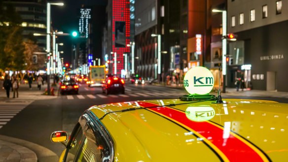 A taxi in a Ginza street at night in Tokyo. 