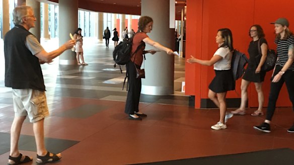 Louise Sales and (left) Bob Phelps of Gene Ethics hand out pamphlets at the Melbourne Convention Centre during the forum. 