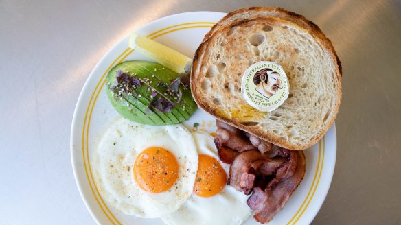 The fried eggs and toast, with avocado and bacon.