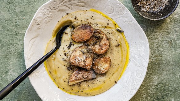 Carb on carb: Creamy potato soup topped with roasties and porcini salt.