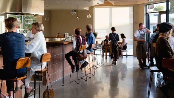 The room is cosy, with a mix of tables and bar seating.