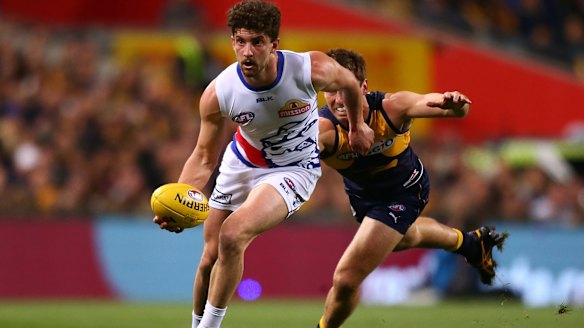 Tom Liberatore helps the Bulldogs to an elimination final win over West Coast last year. A last-round wildcard weekend could radically re-shape the first week of finals.