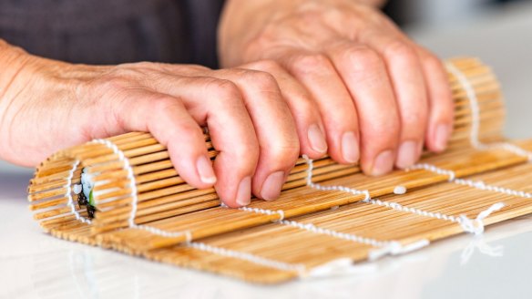 Step-by-step sushi rolls.
Step 4c Pull the end of the bamboo mat out from under your sushi roll as you go.
Pic credit: Nagi Maehashi
For Good Food, April 26, 2022