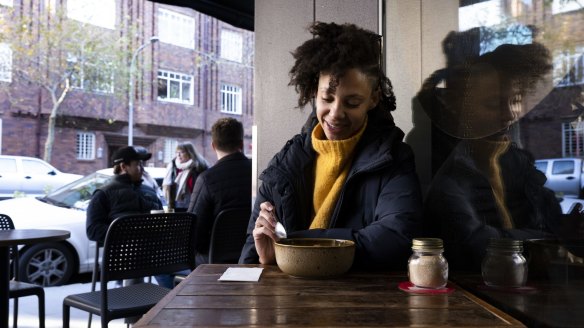 Customer Sophia Ndaba warms up with porridge at Gypsy Espresso.