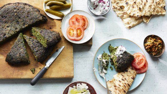 Kuku sabzi, or Persian herb frittata, served with crunchy and acidic condiments.