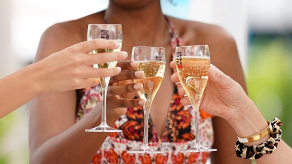 Tennis fans raise a glass in Garden Square at the Australian Open.