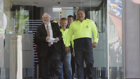 CFMEU organiser John Lomax, right, leaves the court with lawyer John Agius after having a blackmail charge dropped.