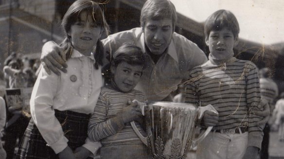 Caroline Wilson with sister Amelia, brother Will, Bill Barrot and the Richmond 1969 premiership cup.